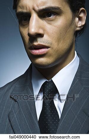 Businessman looking away angrily View Large Photo Image Stock Image - Businessman looking away angrily. Fotosearch