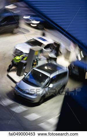 Stock Image - Car's refueling at gas station, high angle view. Fotosearch