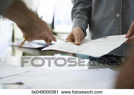 Colleagues reviewing document together View Large Photo Image Stock Image - Colleagues reviewing document together. Fotosearch