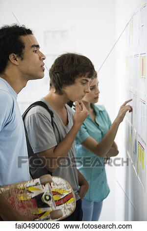 College students apprehensively checking results posted on bulletin board View Large Photo Image Stock Photograph - College students apprehensively checking results posted on bulletin board. Fotosearch