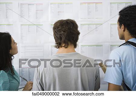 College students checking bulletin board for classroom assignments, rear view View Large Photo Image Stock Image - College students checking bulletin board for classroom assignments, rear view. Fotosearch