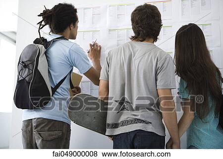 College students checking bulletin board, rear view View Large Photo Image Stock Photo - College students checking bulletin board, rear view. Fotosearch