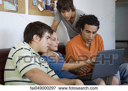College students collaborating on laptop computer View Large Photo Image Stock Photo - College students collaborating on laptop computer. Fotosearch