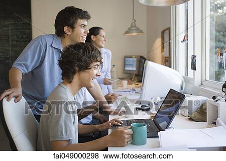 Stock Photo - College students collaborating on project. Fotosearch