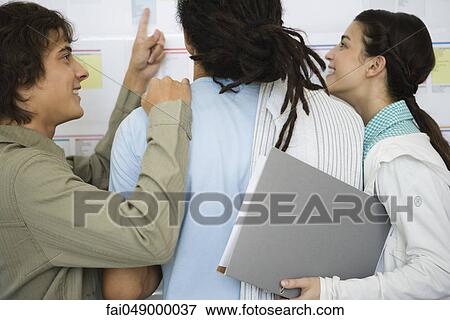 College students excitedly checking results posted on bulletin board View Large Photo Image Stock Photo - College students excitedly checking results posted on bulletin board. Fotosearch