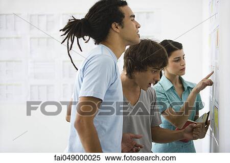 College students looking at results posted on bulletin board View Large Photo Image Stock Photography - College students looking at results posted on bulletin board. Fotosearch