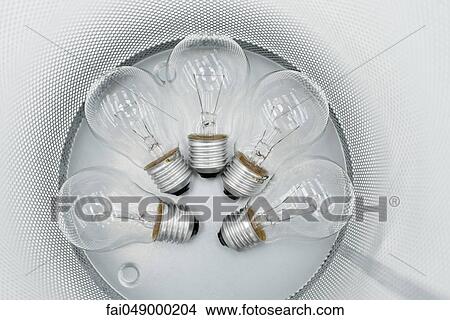 Picture - Conventional light bulbs in garbage can. Fotosearch