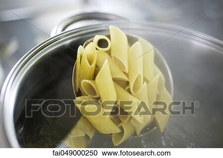 Stock Image - Cooking penne pasta. Fotosearch
