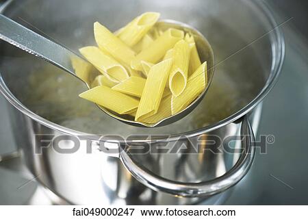 Stock Photo - Cooking penne pasta. Fotosearch
