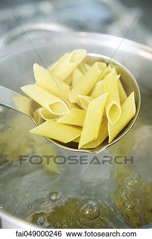 Cooking penne pasta View Large Photo Image Stock Photograph - Cooking penne pasta. Fotosearch
