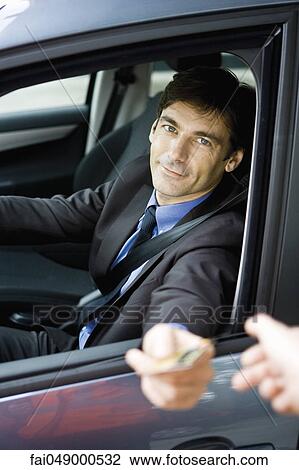 Customer in drive-thru handing credit card to check-out window clerk View Large Photo Image Stock Image - Customer in drive-thru handing credit card to check-out window clerk. Fotosearch