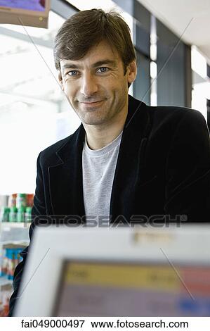 Stock Photo - Customer waiting at checkout counter. Fotosearch
