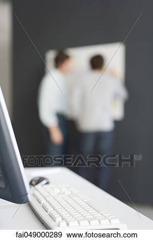 Desktop computer and keyboard, unrecognizable men in background View Large Photo Image Stock Photo - Desktop computer and keyboard, unrecognizable men in background. Fotosearch