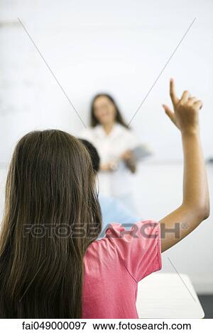 Elementary school student raising hand in class, rear view View Large Photo Image Stock Photo - Elementary school student raising hand in class, rear view. Fotosearch