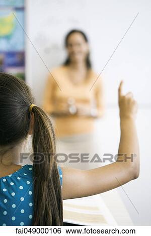 Elementary school student raising hand in class View Large Photo Image Stock Photograph - Elementary school student raising hand in class. Fotosearch