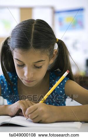 Female elementary school student in class View Large Photo Image Stock Photo - Female elementary school student in class. Fotosearch