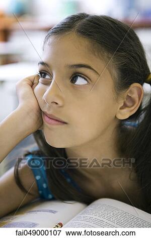 Female elementary school student daydreaming in class View Large Photo Image Stock Photo - Female elementary school student daydreaming in class. Fotosearch