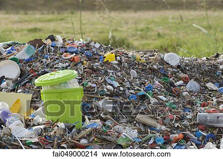 Full garbage can in midst of landfill View Large Photo Image Picture - Full garbage can in midst of landfill. Fotosearch
