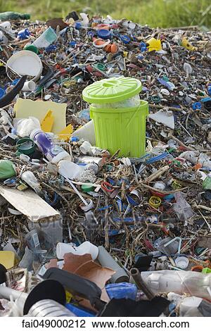 Full garbage can in midst of landfill View Large Photo Image Stock Image - Full garbage can in midst of landfill. Fotosearch
