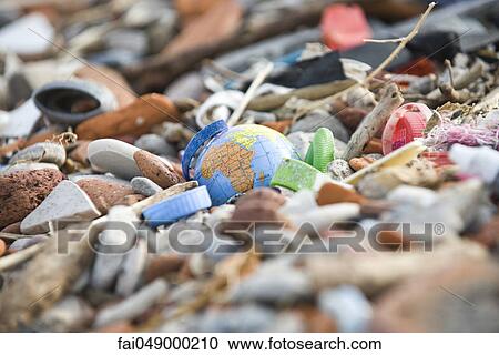 Globe surrounded and nearly covered by pile of trash View Large Photo Image Stock Image - Globe surrounded and nearly covered by pile of trash. Fotosearch