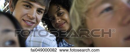 Group of young adult friends, smiling View Large Photo Image Stock Image - Group of young adult friends, smiling. Fotosearch