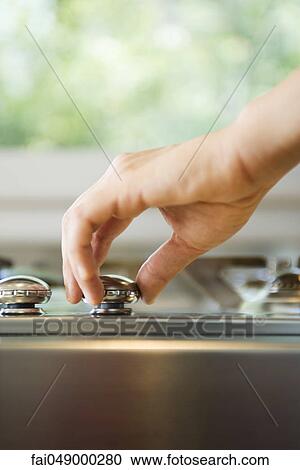 Hand adjusting stove knob View Large Photo Image Stock Image - Hand adjusting stove knob. Fotosearch