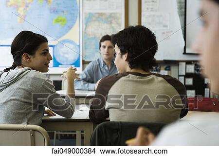 High school student speaking with classmate in class View Large Photo Image Picture - High school student speaking with classmate in class. Fotosearch