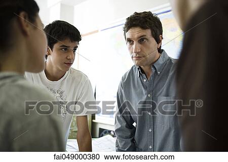 High school students chatting with teacher after class View Large Photo Image Stock Image - High school students chatting with teacher after class. Fotosearch