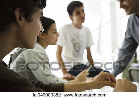 High school students chatting with teacher after class View Large Photo Image Stock Image - High school students chatting with teacher after class. Fotosearch