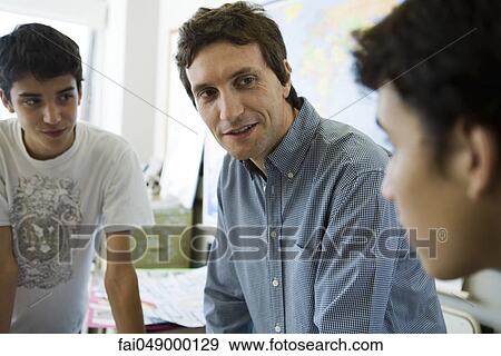 High school students having casual conversation with teacher View Large Photo Image Stock Photo - High school students having casual conversation with teacher. Fotosearch