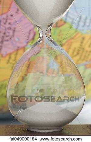 Hourglass, map in background View Large Photo Image Picture - Hourglass, map in background. Fotosearch