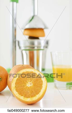 Making fresh-squeezed orange juice View Large Photo Image Stock Photo - Making fresh-squeezed orange juice. Fotosearch