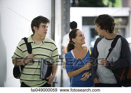 Male and female students walking and chatting together View Large Photo Image Stock Photo - Male and female students walking and chatting together. Fotosearch