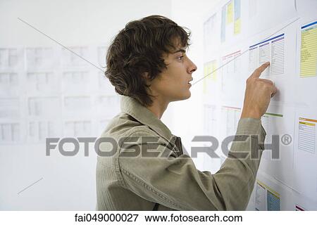 Male college student checking results posted on bulletin board View Large Photo Image Stock Photo - Male college student checking results posted on bulletin board. Fotosearch