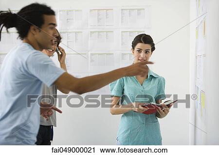 Male college student excitedly pointing at results posted on bulletin board, classmates in background watching View Large Photo Image Stock Image - Male college student excitedly pointing at results posted on bulletin board, classmates in background watching. Fotosearch