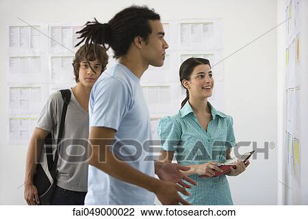Male college student staring with disbelief at results posted on bulletin board, friends watching in background View Large Photo Image Stock Image - Male college student staring with disbelief at results posted on bulletin board, friends watching in background. Fotosearch