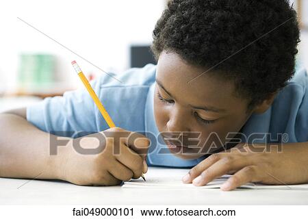 Male elementary school student concentrating on classwork View Large Photo Image Stock Image - Male elementary school student concentrating on classwork. Fotosearch