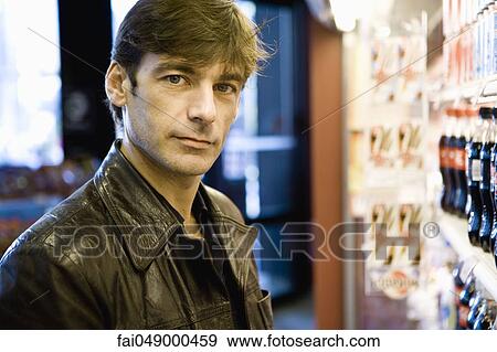 Man at soft drink cooler in convenience store View Large Photo Image Stock Photo - Man at soft drink cooler in convenience store. Fotosearch
