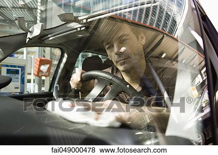 Man cleaning car dashboard View Large Photo Image Stock Photo - Man cleaning car dashboard. Fotosearch