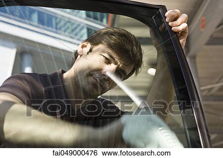 Man cleaning car door window View Large Photo Image Stock Photograph - Man cleaning car door window. Fotosearch