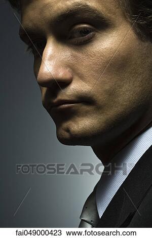 Man eying camera with suspicion View Large Photo Image Stock Image - Man eying camera with suspicion. Fotosearch