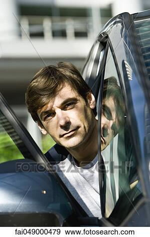 Man getting out of car View Large Photo Image Stock Photo - Man getting out of car. Fotosearch