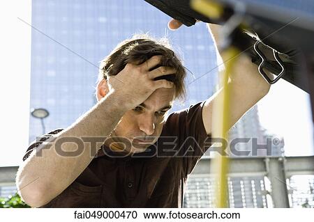 Man holding head, raising hood of car View Large Photo Image Stock Image - Man holding head, raising hood of car. Fotosearch