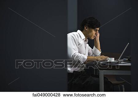 Man in office working late View Large Photo Image Stock Photo - Man in office working late. Fotosearch