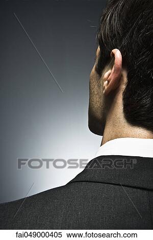 Man looking away with air of uncertainty, rear view View Large Photo Image Stock Photography - Man looking away with air of uncertainty, rear view. Fotosearch