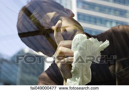 Man scrutinizing spot on car window glass View Large Photo Image Stock Photo - Man scrutinizing spot on car window glass. Fotosearch