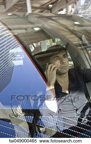 Man using cell phone while driving View Large Photo Image Stock Photography - Man using cell phone while driving. Fotosearch