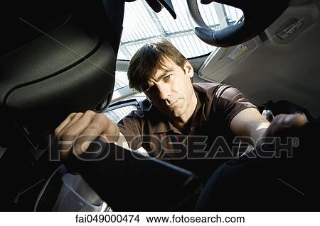 Man vacuuming interior of car View Large Photo Image Picture - Man vacuuming interior of car. Fotosearch