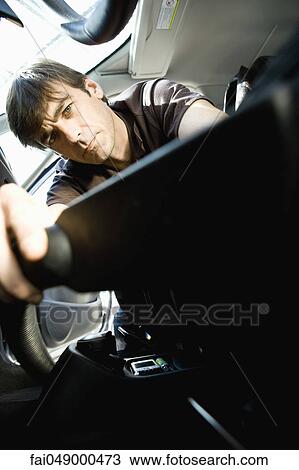Man vacuuming interior of car View Large Photo Image Stock Image - Man vacuuming interior of car. Fotosearch