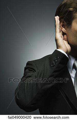 Man with hand cupped around ear listening attentively View Large Photo Image Stock Image - Man with hand cupped around ear listening attentively. Fotosearch